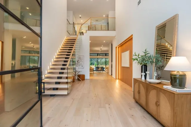 a view of a room with wooden floor and stairs