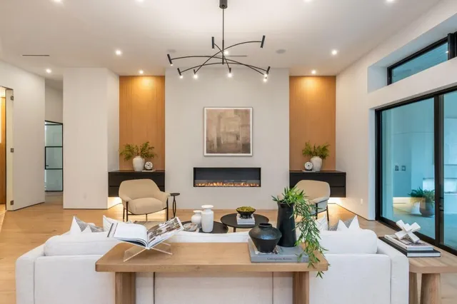 a living room with furniture and a chandelier