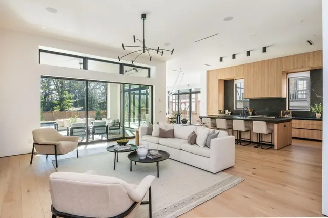 a living room with furniture and view of kitchen