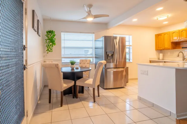 a dining room with furniture and a window