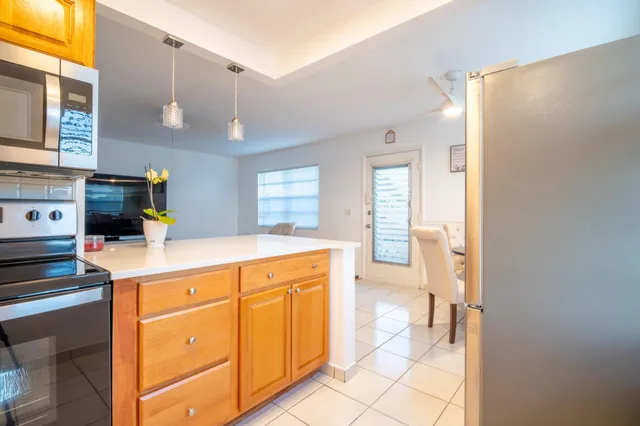 a kitchen with stainless steel appliances a sink and a refrigerator