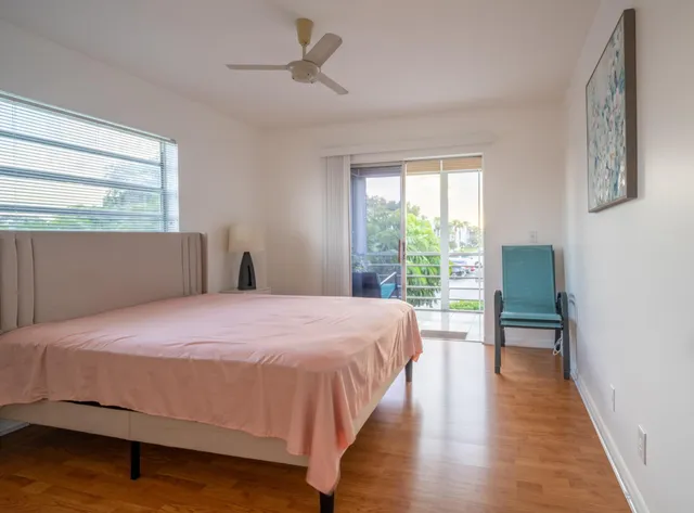a bedroom with a bed and a large window