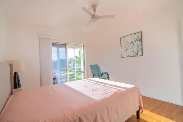 a bedroom with a large bed and a window