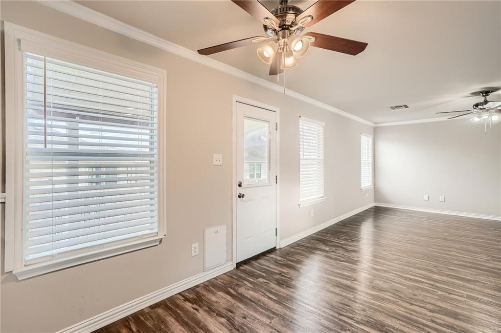 612 Copper Court Jarrell, TX 76537 - Photo 11 of 27 a view of an empty room with a window and wooden floor