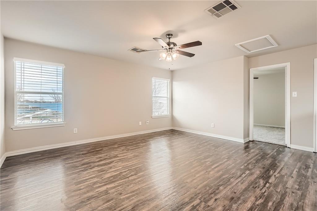 612 Copper Court Jarrell, TX 76537 - Photo 15 of 27 a view of an empty room with a window and wooden floor