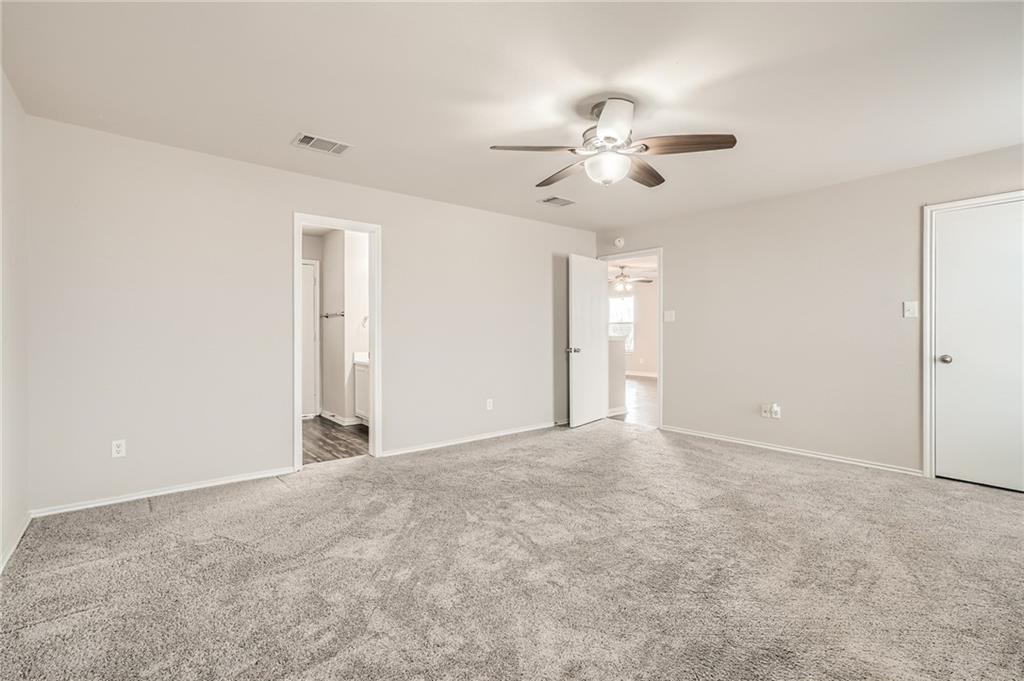 612 Copper Court Jarrell, TX 76537 - Photo 17 of 27 an empty room with windows and fan