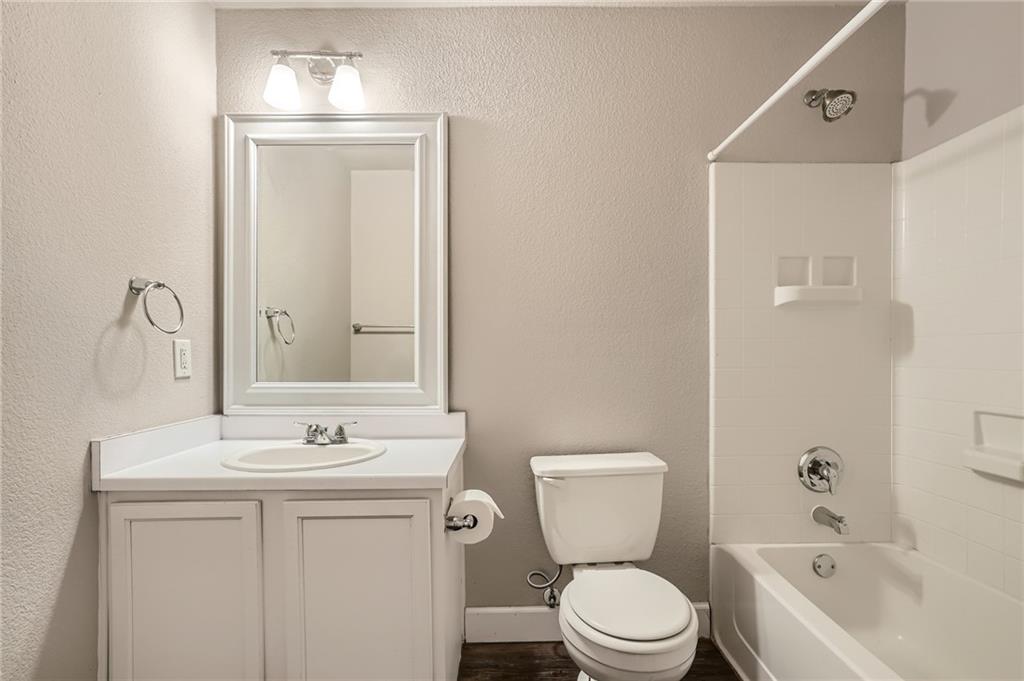 612 Copper Court Jarrell, TX 76537 - Photo 22 of 27 a bathroom with a toilet sink and mirror