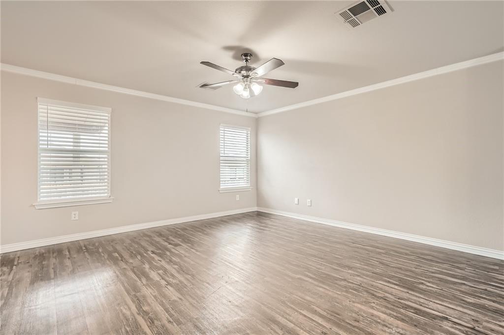 612 Copper Court Jarrell, TX 76537 - Photo 5 of 27 wooden floor in an empty room with a window