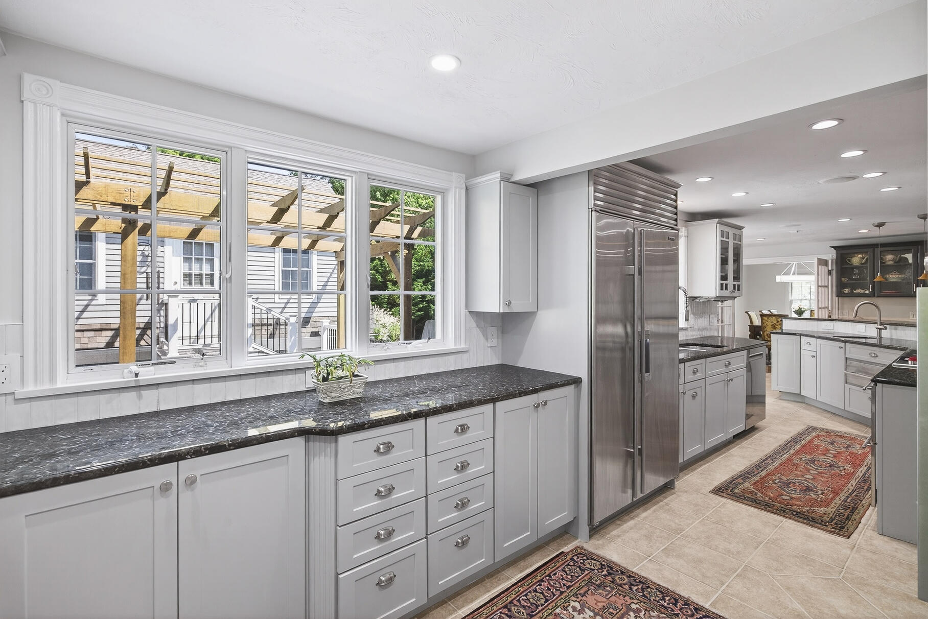 72 River Road Marstons Mills, MA 02648 - Photo 24 of 65 a kitchen with granite countertop a stove a sink and a refrigerator