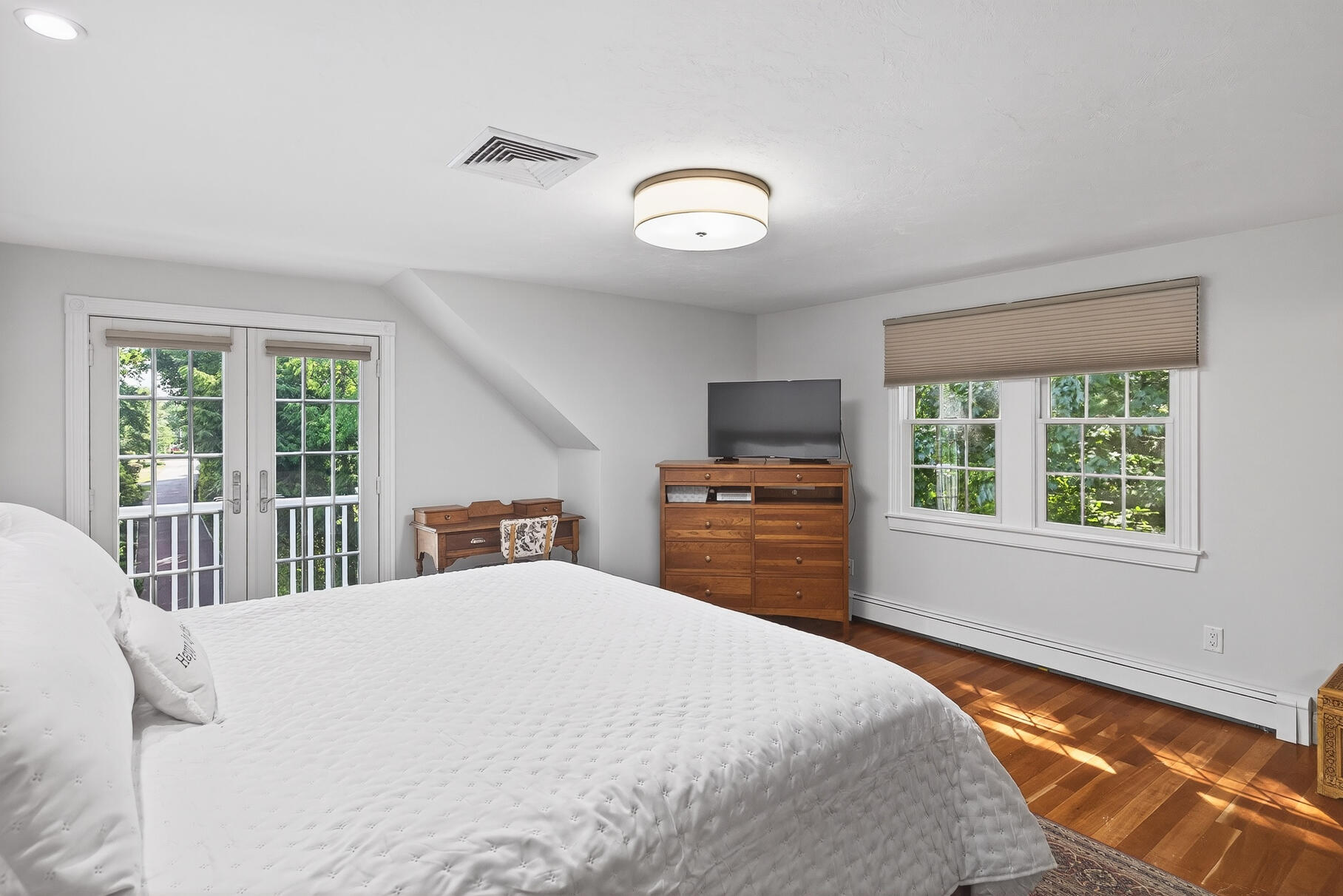 72 River Road Marstons Mills, MA 02648 - Photo 36 of 65 a bedroom with a large bed and a tv