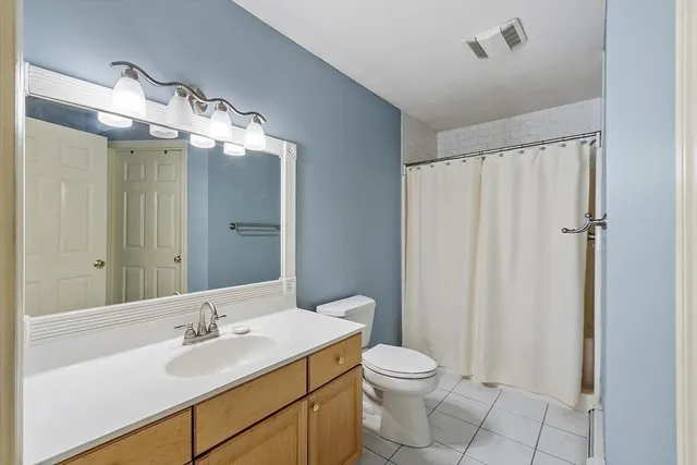 a bathroom with a sink mirror and toilet