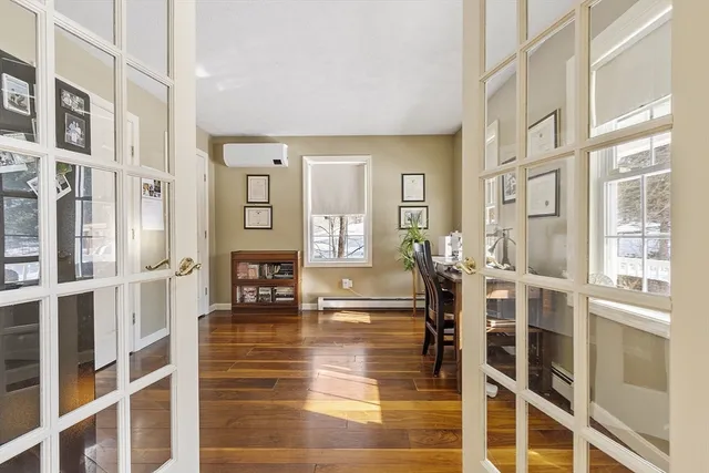 a living room with fireplace furniture and a large window