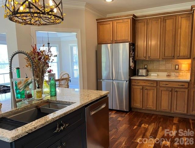 183 Burl Bridges Road Forest City, NC 28043 - Photo 22 of 31 a kitchen with stainless steel appliances granite countertop a refrigerator a sink dishwasher and wooden cabinets with wooden floor