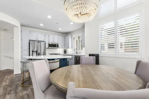 a living room with stainless steel appliances kitchen island granite countertop furniture and a kitchen view