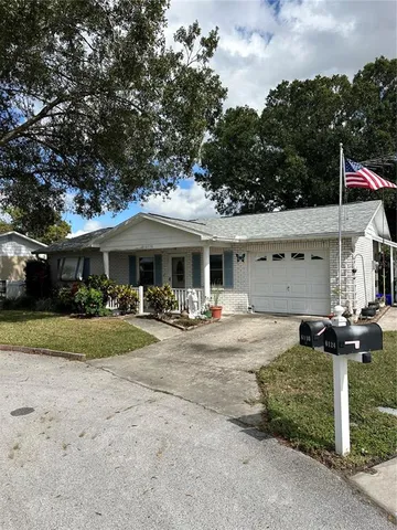 a front view of a house with yard and garage