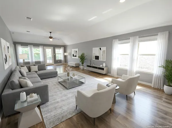 a living room with furniture and wooden floor