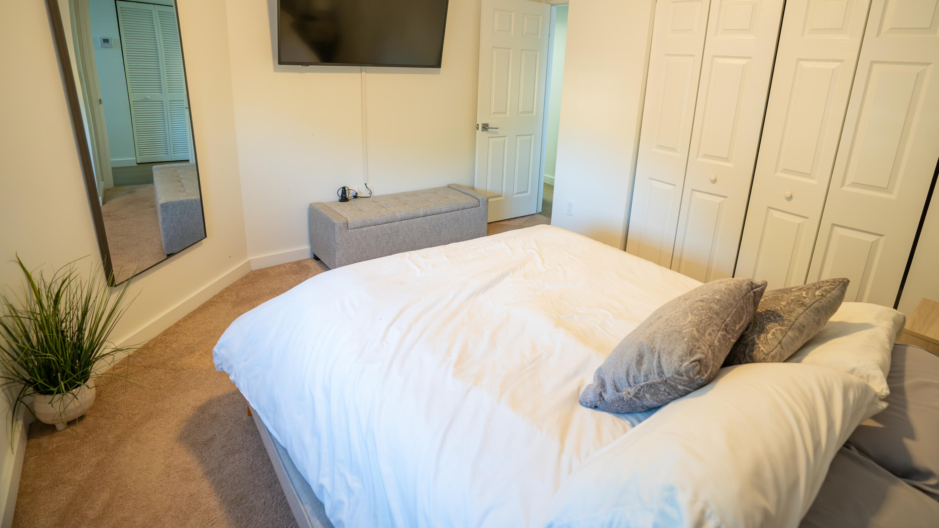 1330 Crystal Way, Unit 107 Delray Beach, FL 33444 - Photo 13 of 23 a bedroom with a bed and a flat screen tv