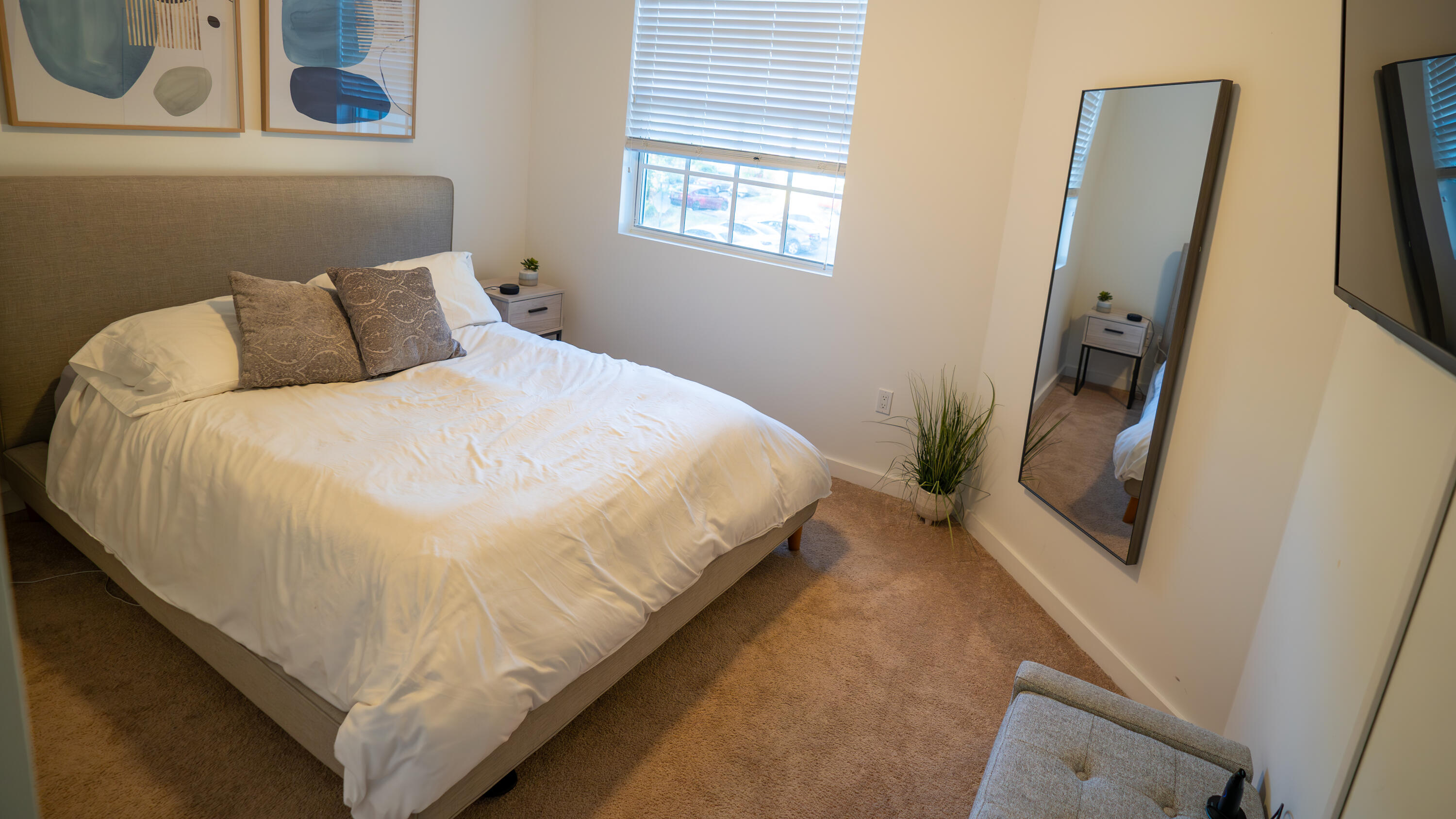 1330 Crystal Way, Unit 107 Delray Beach, FL 33444 - Photo 14 of 23 a bed sitting in a bedroom next to a window
