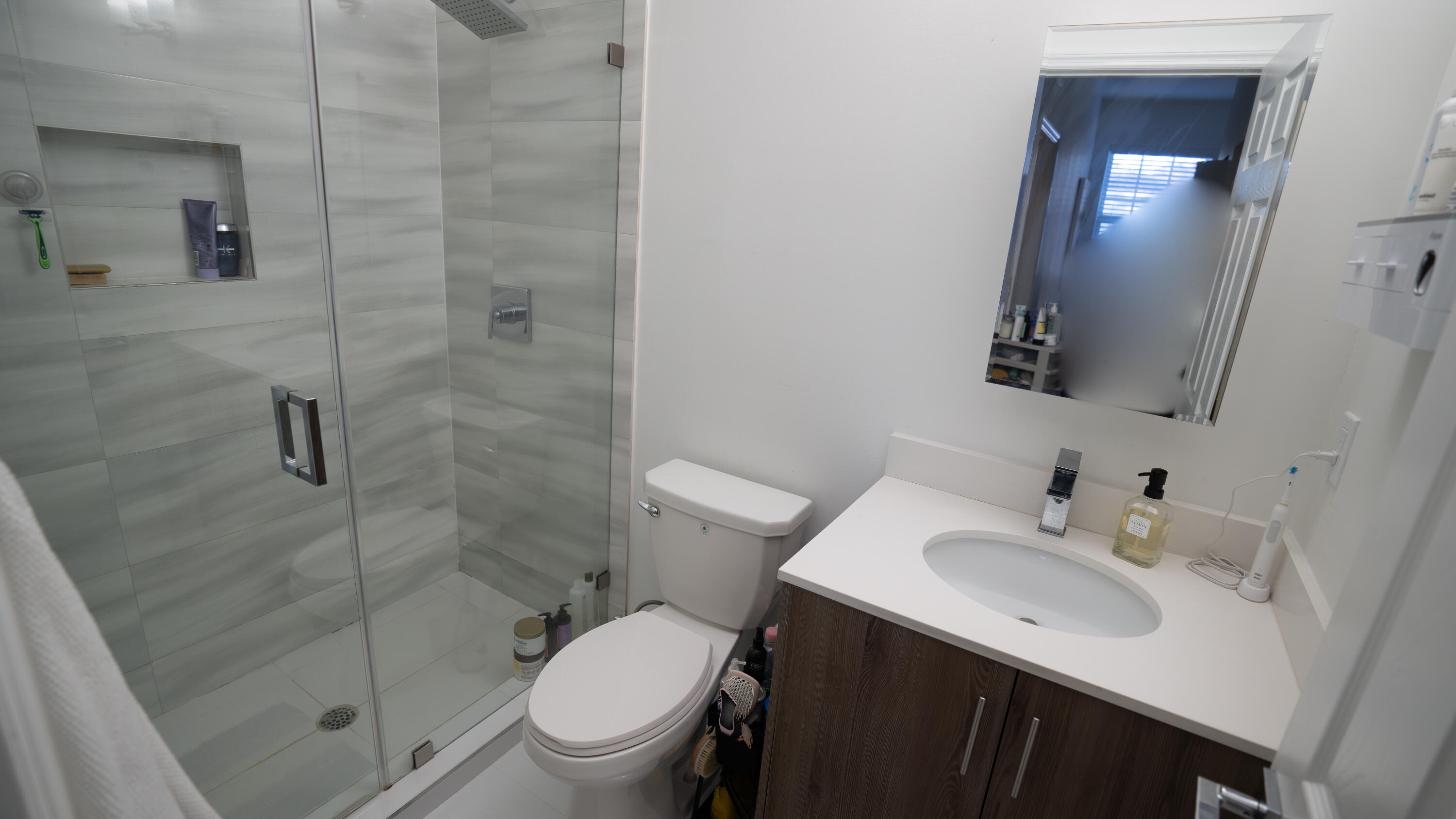 1330 Crystal Way, Unit 107 Delray Beach, FL 33444 - Photo 15 of 23 a bathroom with a sink toilet and shower
