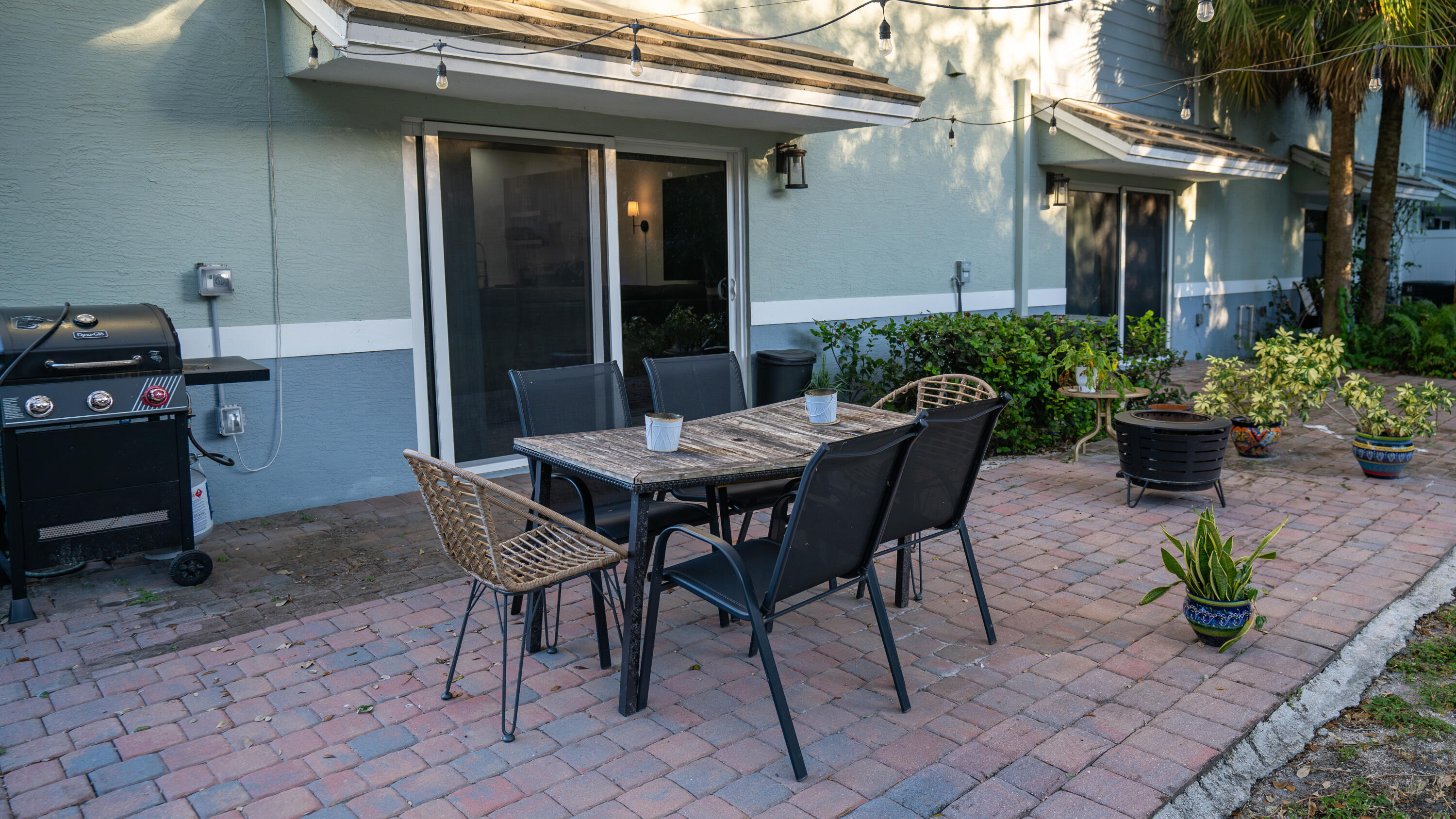 1330 Crystal Way, Unit 107 Delray Beach, FL 33444 - Photo 19 of 23 a view of a patio with table and chairs potted plants