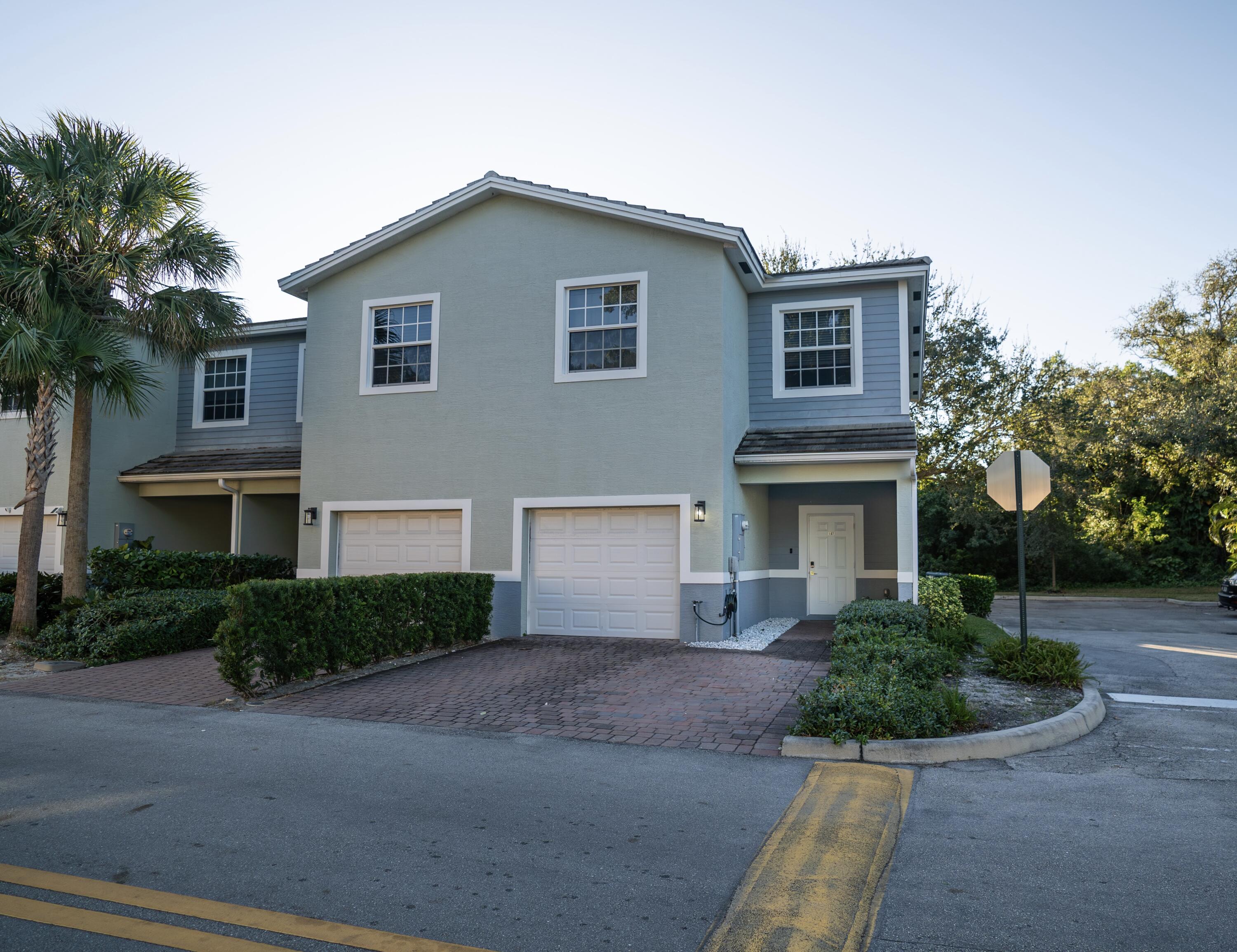 1330 Crystal Way, Unit 107 Delray Beach, FL 33444 - Photo 20 of 23 a front view of a house with garden