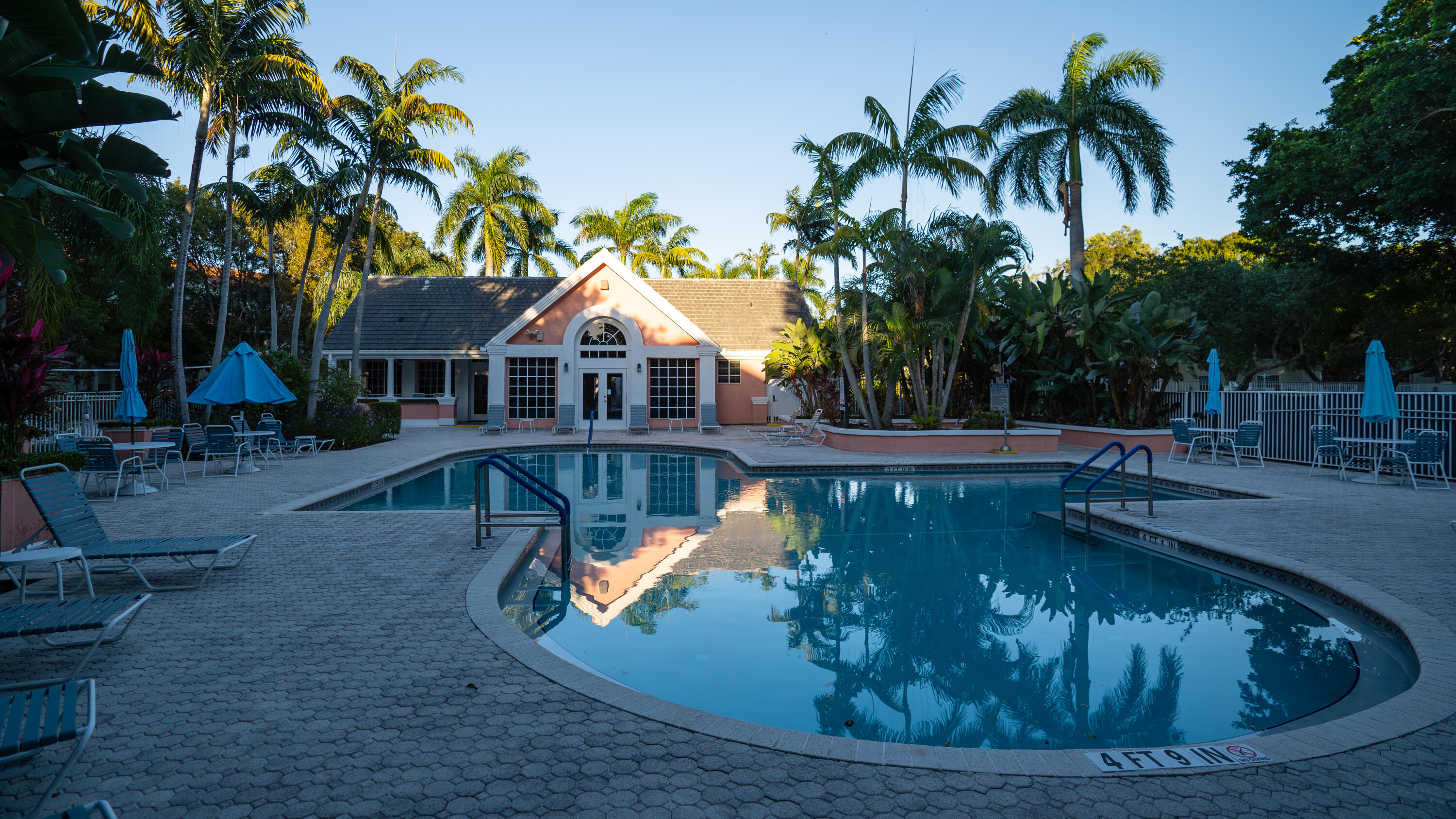 1330 Crystal Way, Unit 107 Delray Beach, FL 33444 - Photo 21 of 23 a view of a swimming pool with a patio