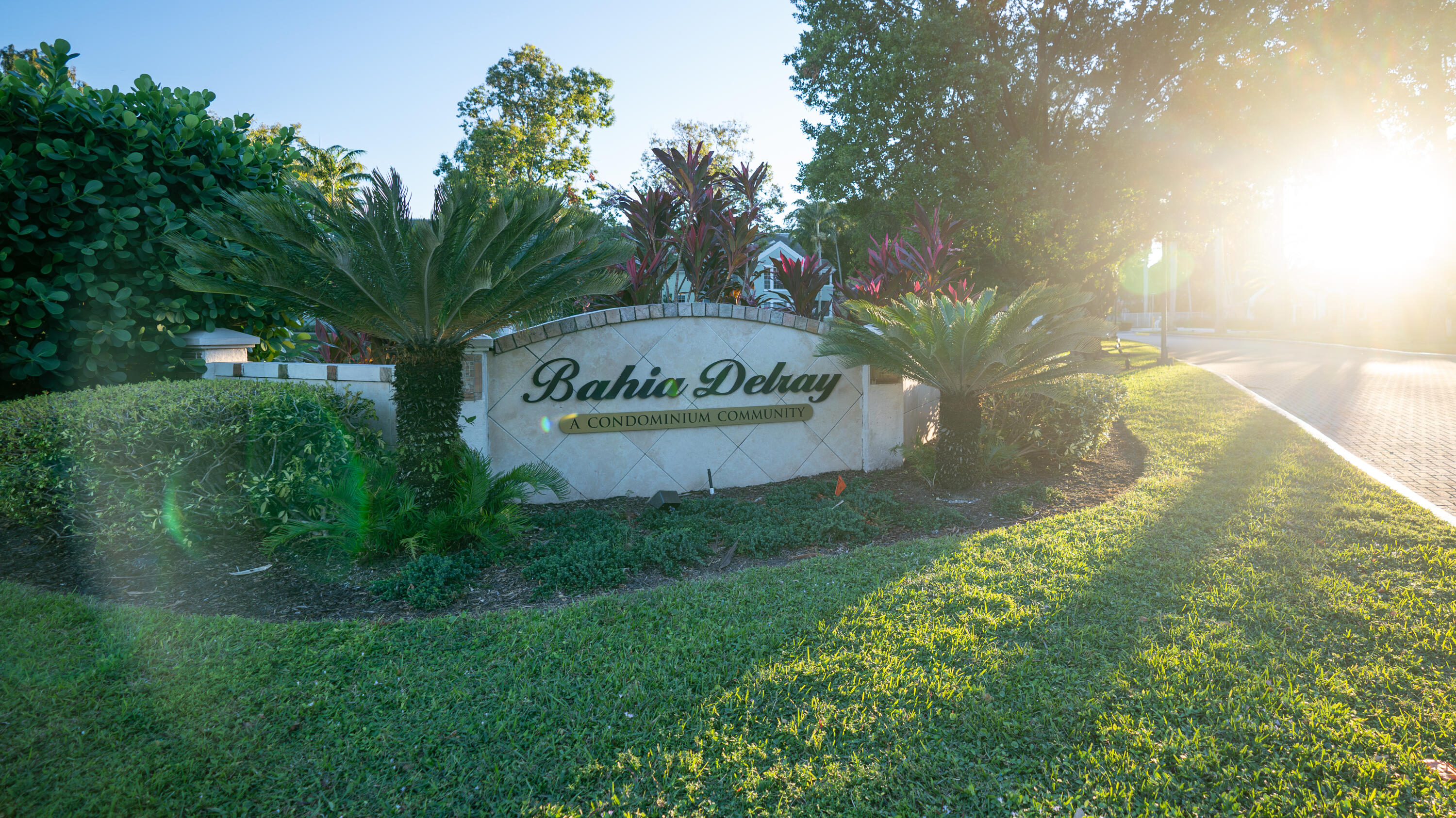 1330 Crystal Way, Unit 107 Delray Beach, FL 33444 - Photo 23 of 23 a sign of golf club on a wall under a tree