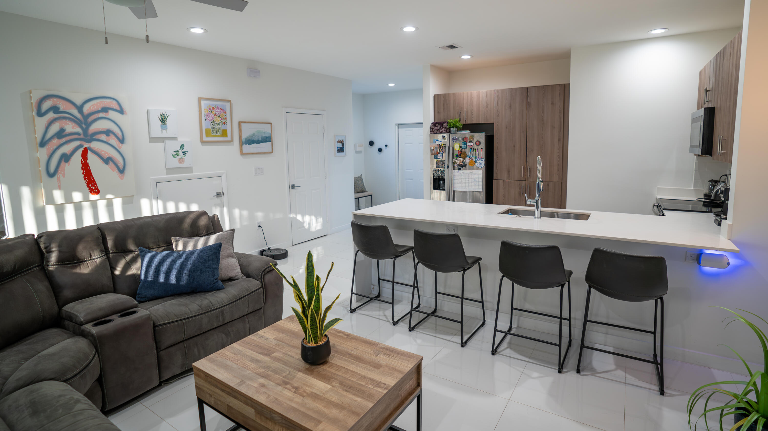 1330 Crystal Way, Unit 107 Delray Beach, FL 33444 - Photo 5 of 23 a living room with furniture and a refrigerator