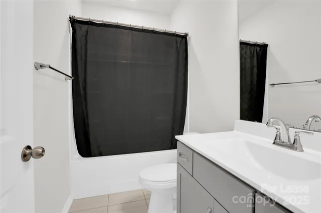 a bathroom with a sink a toilet a shower and a mirror