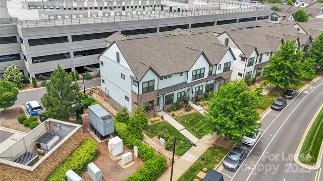 an aerial view of a house with a yard and balcony