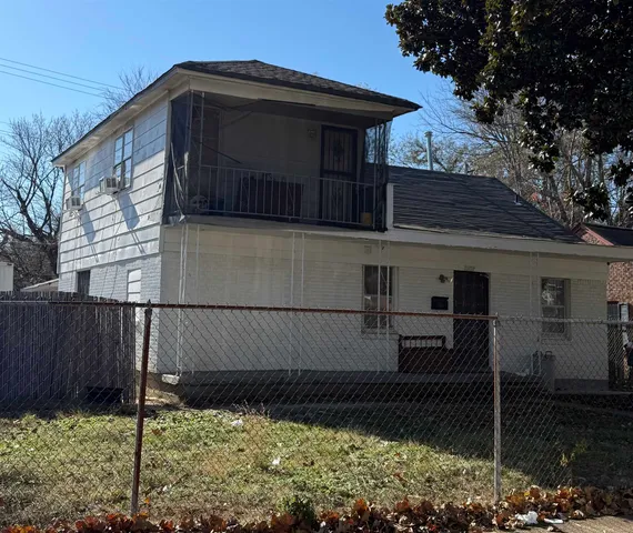 a view of a house with a wooden fence