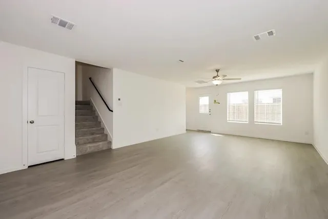 a kitchen with a sink white cabinets and stainless steel appliances