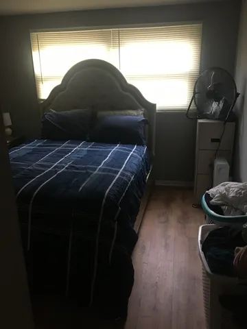a bedroom with a bed and a window