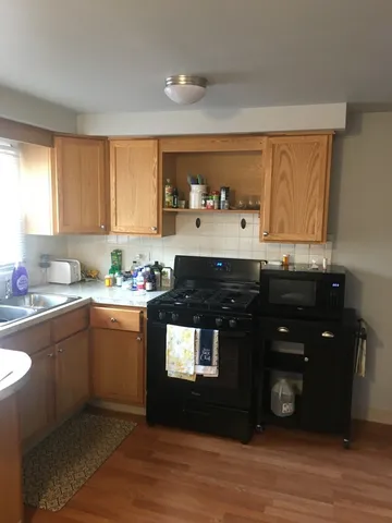 a kitchen with a sink a stove and cabinets