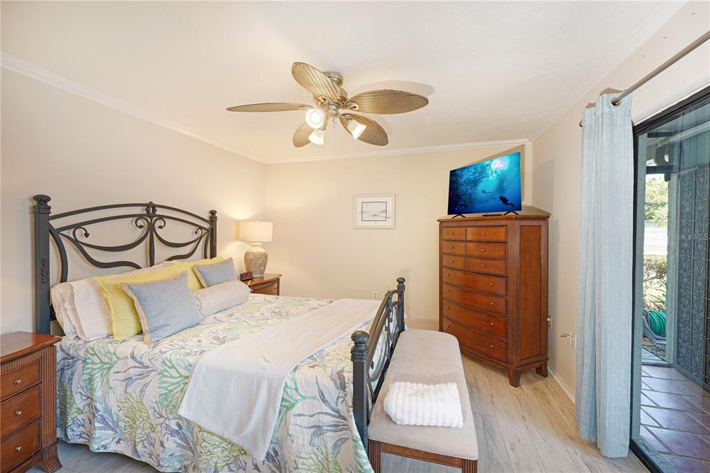 5903 43rd Street West, Unit 5903 Bradenton, FL 34210 - Photo 11 of 12 a bedroom with a bed and a chandelier