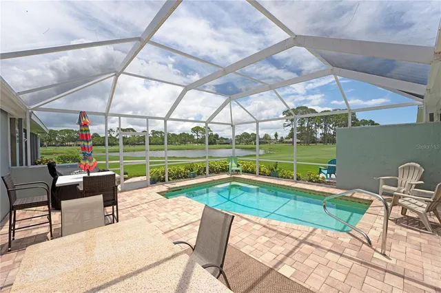 a swimming pool with outdoor seating and yard