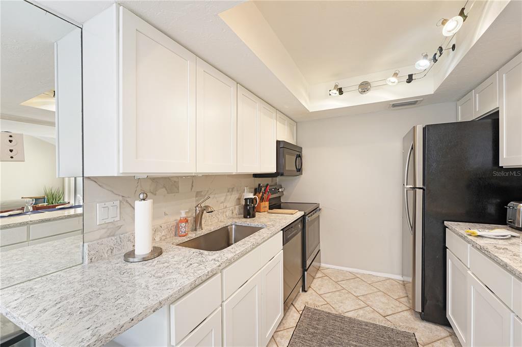 5903 43rd Street West, Unit 5903 Bradenton, FL 34210 - Photo 3 of 12 a kitchen with a sink stove and refrigerator