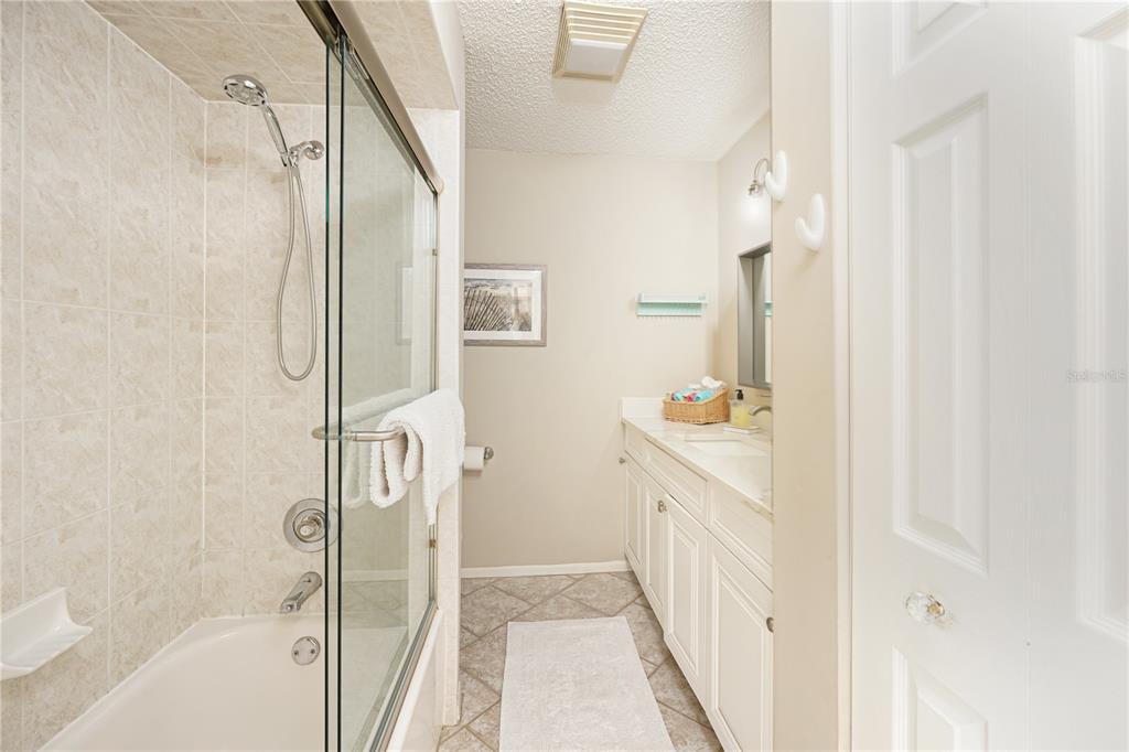 5903 43rd Street West, Unit 5903 Bradenton, FL 34210 - Photo 7 of 12 a bathroom with a sink a mirror and a bathtub