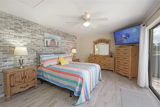 a bedroom with a bed and a lamp on dresser