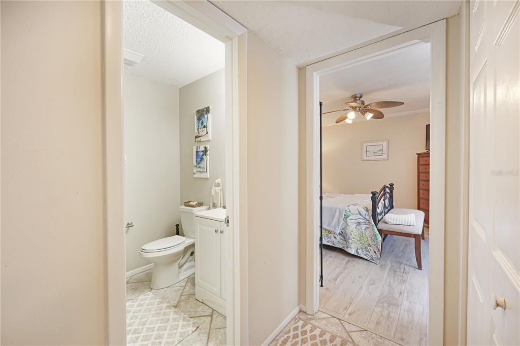 5903 43rd Street West, Unit 5903 Bradenton, FL 34210 - Photo 9 of 12 a bathroom with a granite countertop toilet a sink and a mirror