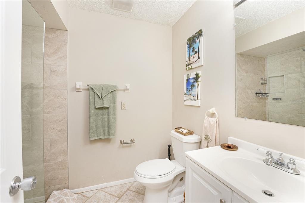 5903 43rd Street West, Unit 5903 Bradenton, FL 34210 - Photo 10 of 12 a bathroom with a sink toilet and a mirror