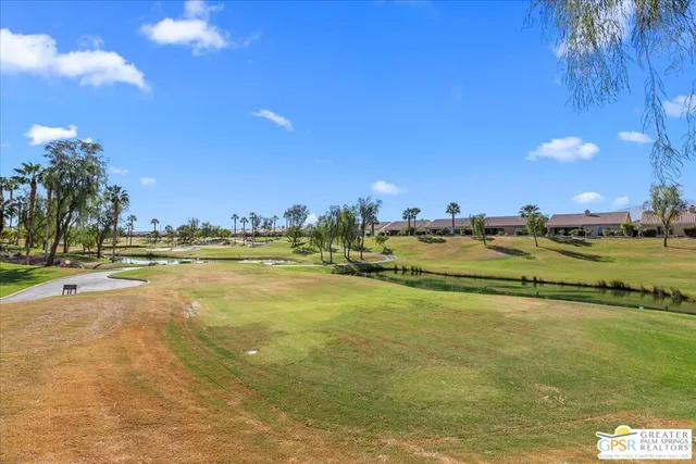 a view of a room with wooden floor and furniture