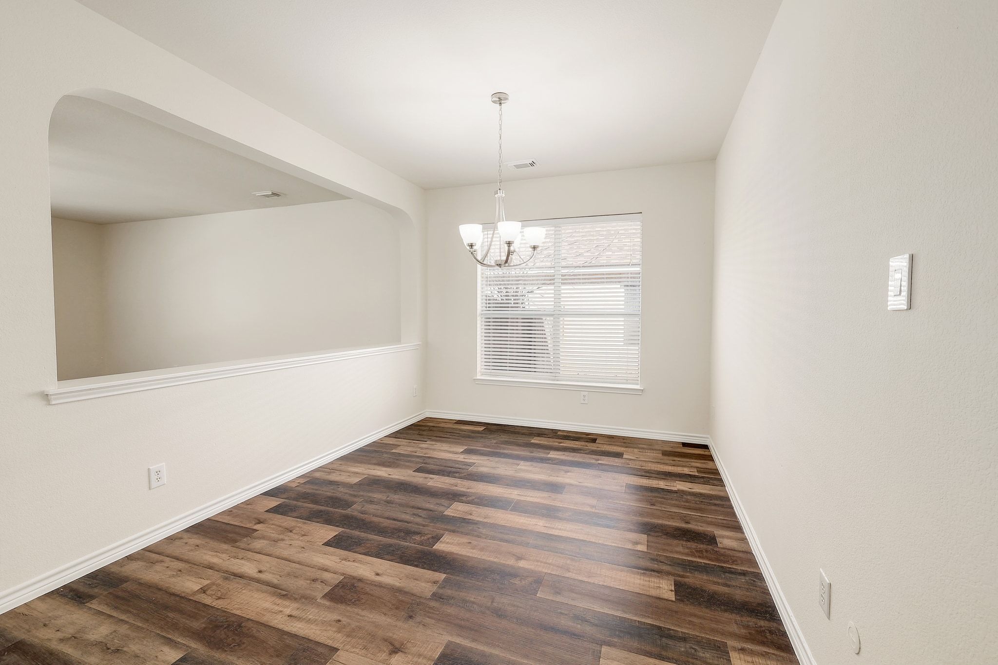 2307 Hayfield Square Pflugerville, TX 78660 - Photo 17 of 40 a view of an empty room with window and wooden floor