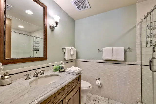 a bedroom with a bed a bookshelf and a window