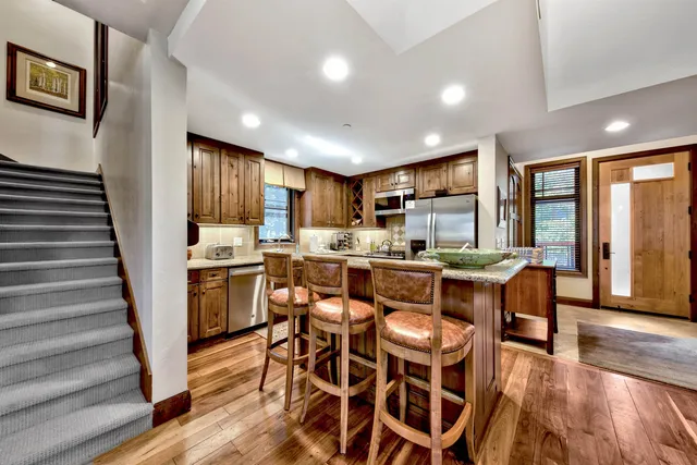 a kitchen with granite countertop a sink and cabinets