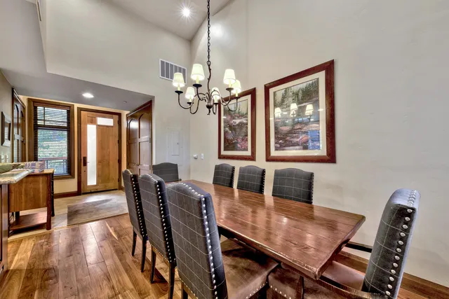 a bedroom with a bed and large windows