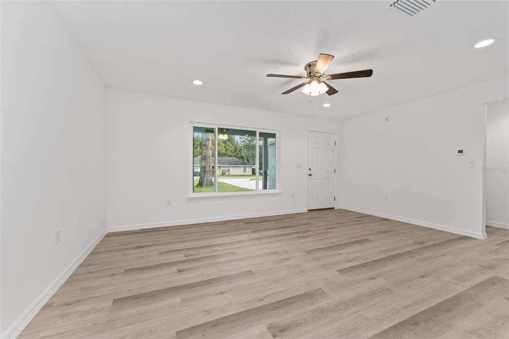 13119 Northeast 7th Loop Silver Springs, FL 34488 - Photo 13 of 51 an empty room with windows and fan