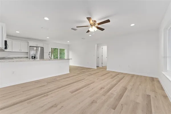 a kitchen with stainless steel appliances granite countertop a refrigerator sink and cabinets
