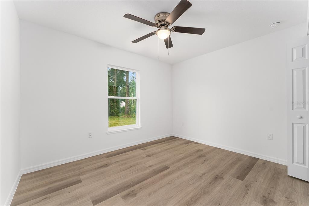 13119 Northeast 7th Loop Silver Springs, FL 34488 - Photo 32 of 51 wooden floor in an empty room with a window