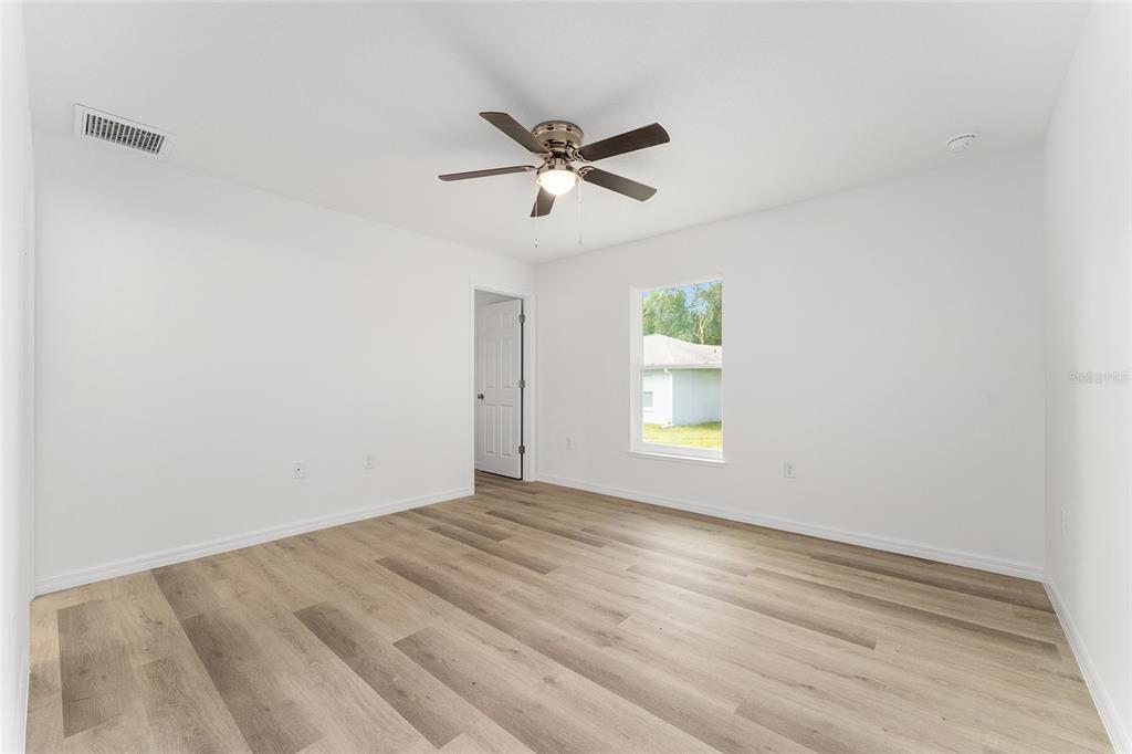 13119 Northeast 7th Loop Silver Springs, FL 34488 - Photo 39 of 51 a view of empty room with window and ceiling fan